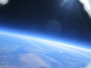 The curvature of the earth and rays of the sun in the upper atmosphere as recorded by the satellite